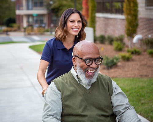 resident showing caregiver something on phone