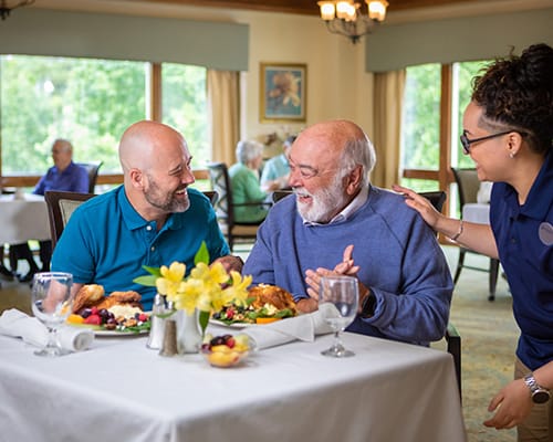 caregiver helping a resident paint