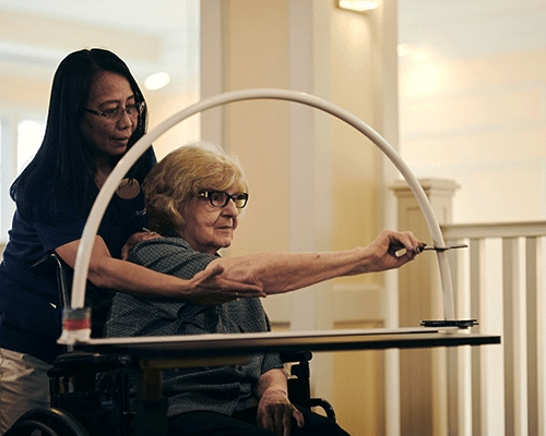 caregiver helps resident with a memory care activity