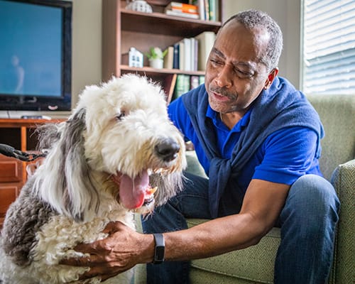 man petting dog