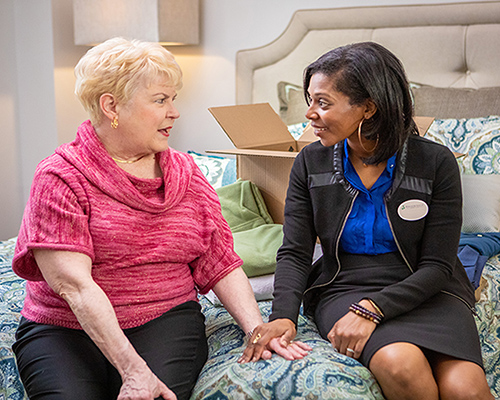 caregiver and resident scrapbooking together