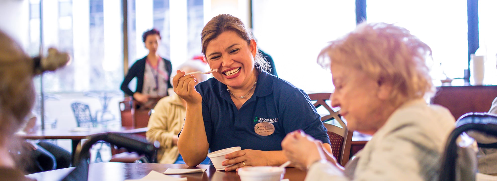 female associate eating ice cream with residents