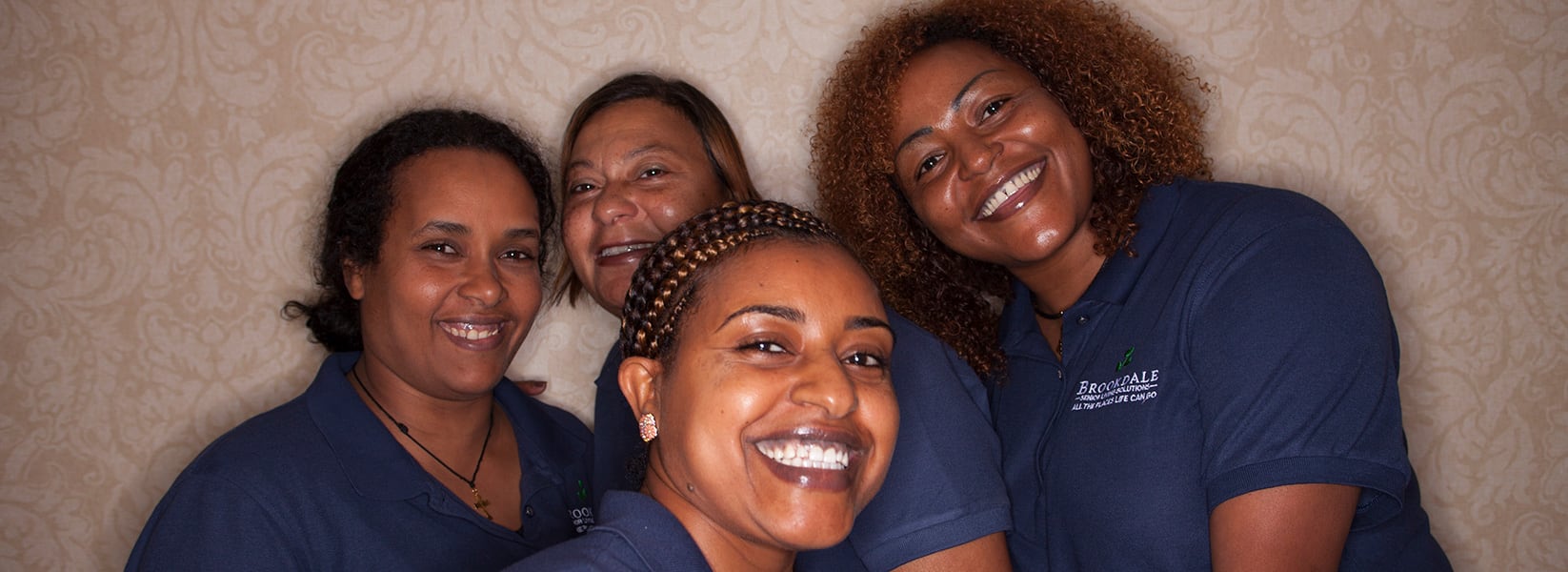 Four female Brookdale associates smiling