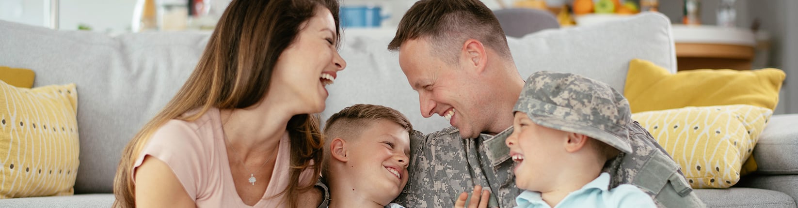 veteran and family on couch laughing